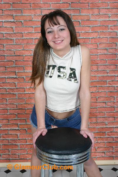 Honey B denim shorts and crop top posing with stool